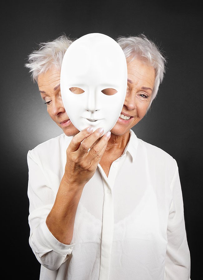 older woman hiding happy and sad face behind mask
